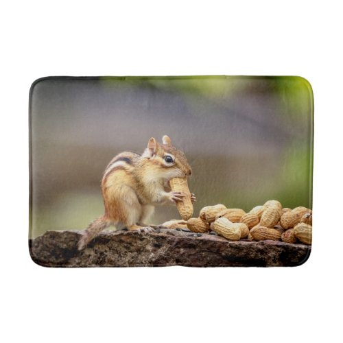 Chipmunk eating a peanut bath mat