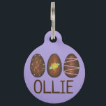 Chocolate Buttercream Easter Egg Hunt Candy Purple Pet Name Tag<br><div class="desc">Pet tag design features an original illustration of a row of chocolate buttercream Easter eggs. Just personalize with the name of your dog or cat. Lots of coordinating pet products are also available from this shop! Don't see exactly what you're looking for? Contact Rebecca to have a product customized just...</div>
