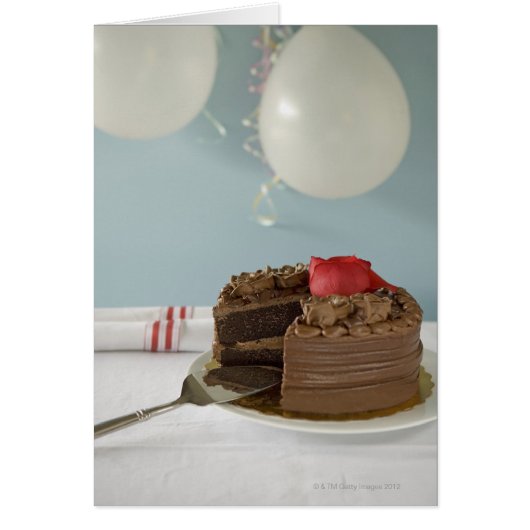Chocolate cake with missing slice on table, cards (Front)