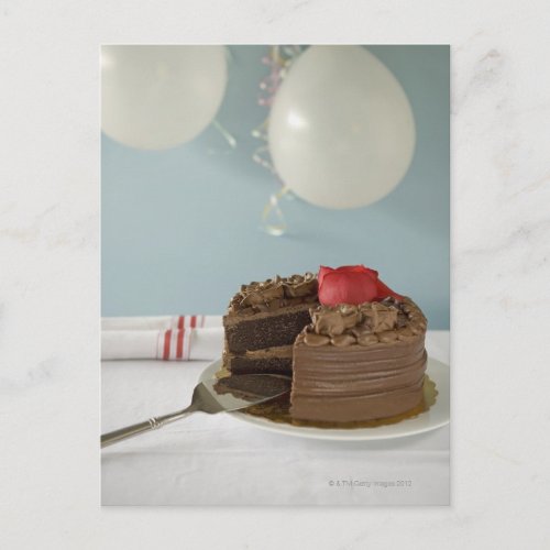 Chocolate cake with missing slice on table postcard