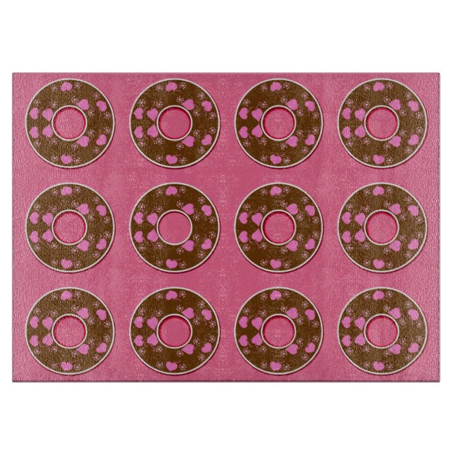 Chocolate donuts doughnuts on pink cutting board (Front)