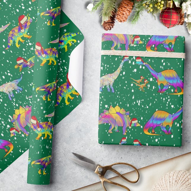 Christmas Dinosaurs in Cute Santa Hats Wrapping Paper (Christmas dinosaurs wearing Santa hats in the snow green wrapping paper cute Jurassic dino pattern)