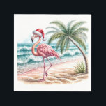 Christmas Flamingo On a Beach Napkins<br><div class="desc">A flamingo wearing a Santa hat strolls along a sandy beach with waves gently crashing nearby</div>
