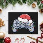 Christmas Gamer Controller Santa Hat Lights Holiday Card<br><div class="desc">This festive gamer design features a video game controller wearing a red Santa hat and wrapped in colorful Christmas lights on a black background. The playful holiday details give the artwork a fun seasonal feel while keeping the gaming theme clear and easy to recognize. It is a strong fit for...</div>