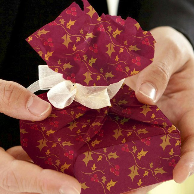 Christmas golden holly and red berries on deep red tissue paper (Creator Uploaded)