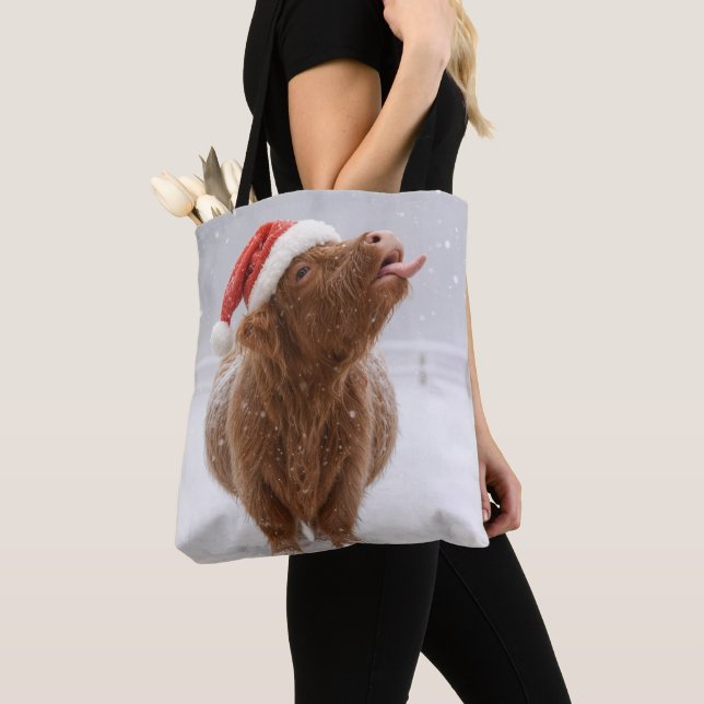 Christmas Highland Cow Catching Snowflakes Tote Bag (Close Up)