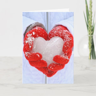 Christmas ice heart in red gloves holiday card