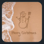 Christmas in Summer Square Sticker<br><div class="desc">Sunny Christmas illustration featuring a snowman and Merry Christmas written in the sand on the beach next to the ocean.</div>