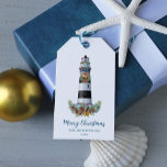 Christmas Lighthouse Nautical Watercolor  Gift Tags<br><div class="desc">Add the finishing touch to your coastal Christmas gift wrapping with these personalized nautical themed gift tags, featuring a black and white lighthouse decorated for the holidays, Merry Christmas script, and family name and year date, with a light aqua blue watercolor texture on the back. Please check out the collection...</div>
