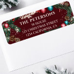 Christmas lights pine branches snow red festive label<br><div class="desc">This elegant return address label features a festive pine garland design adorned with red and teal ornaments, pinecones, and twinkling lights, set against a rich red burgundy background. Perfect for adding a touch of holiday cheer to your Christmas cards, invitations, or packages. Personalize with your family name and address for...</div>