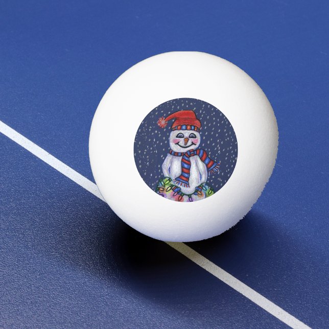 Christmas Lights Smiling Snowman Snowflakes Ping Pong Ball (Smiling snowman in hat scarf holding bright string Christmas lights falling snow on ping pong ball.)