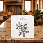 Christmas Love Rustic Greenery Wooden Box Sign<br><div class="desc">This simple design features one simple word with a rustic sprig of green holly with red berries,  pine,  pinecones,  cotton bolls,  and evergreen sprigs. Created by Simply Farmhouse Press.</div>