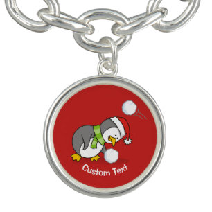 Christmas penguin getting a snow ball charm bracelet
