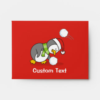 Christmas penguin getting a snow ball envelope