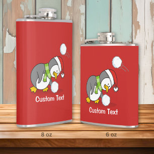 Christmas penguin getting a snow ball hip flask