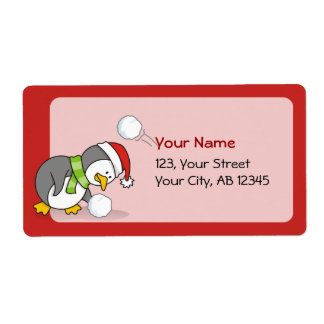 Christmas penguin getting a snow ball label