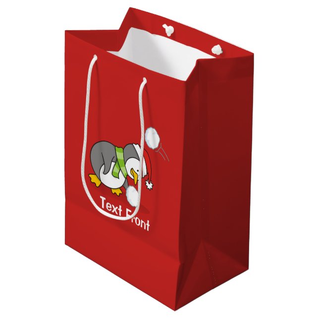 Christmas penguin getting a snow ball medium gift bag (Front Angled)