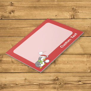 Christmas penguin getting a snow ball notepad
