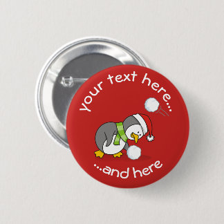 Christmas penguin getting a snow ball pinback button