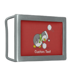 Christmas penguin getting a snow ball rectangular belt buckle