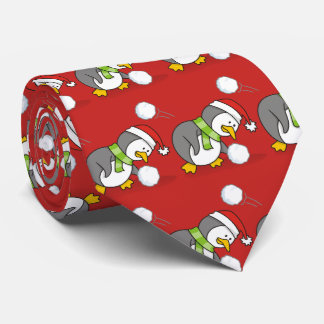 Christmas penguin getting a snow ball tie