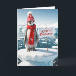 Christmas Penguin On An Iceberg Holiday Card<br><div class="desc">Cute penguin wearing a red cap and scarf perched on an iceberg with a Merry Christmas sign in Antarctica with snowflakes.
Inside text can be changed.</div>