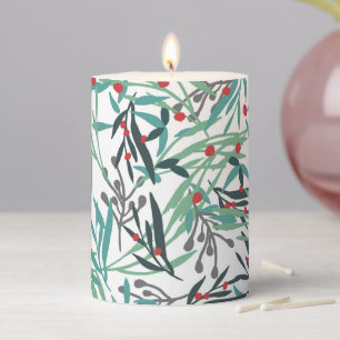 Christmas plant on white pillar candle