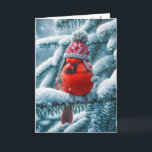 Christmas Red Cardinal Bird Wearing Winter Hat Holiday Card<br><div class="desc">A vibrant red cardinal wearing a knitted hat sits atop a snow-covered evergreen branch,  surrounded by gently falling snowflakes.
Text can be changed.</div>