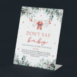 Christmas Red Santa Baby Dont Say Baby Baby Shower Pedestal Sign<br><div class="desc">The Red Christmas Santa Baby Clothes Don’t Say Baby Baby Shower Game Sign brings festive charm and fun to your holiday-themed baby shower. Set against a clean white background, it features red snowflakes, cheerful red berries, winter eucalyptus greenery, and an adorable baby clothesline, inviting guests to enjoy the classic “Don’t...</div>