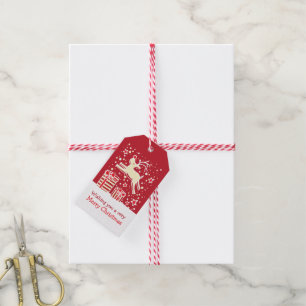 Christmas reindeer prancing over gifts red tag
