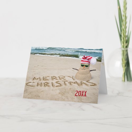 Christmas sandy snowman on beach holiday card