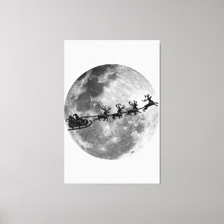 Christmas Santa Claus Flying Past The Moon Canvas Print