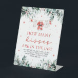 Christmas Santa Guess How Many Kisses Baby Shower  Pedestal Sign<br><div class="desc">The Red Christmas Santa Baby Clothes Guess How Many Kisses Baby Shower Poster is a fun and festive addition to your holiday-themed baby shower. Featuring a charming red backdrop and a cute clothesline of baby clothes, this interactive poster invites guests to guess the number of chocolate kisses in a jar....</div>