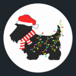 Christmas Scottie Dog With Lights Classic Round Sticker<br><div class="desc">Scottish Terrier dog lovers will enjoy this festive,  black Scottie Dog wearing a Santa hat,  red and white striped scarf and colorful string lights!  Get into the Christmas spirit with this funny design on customizable gifts!</div>