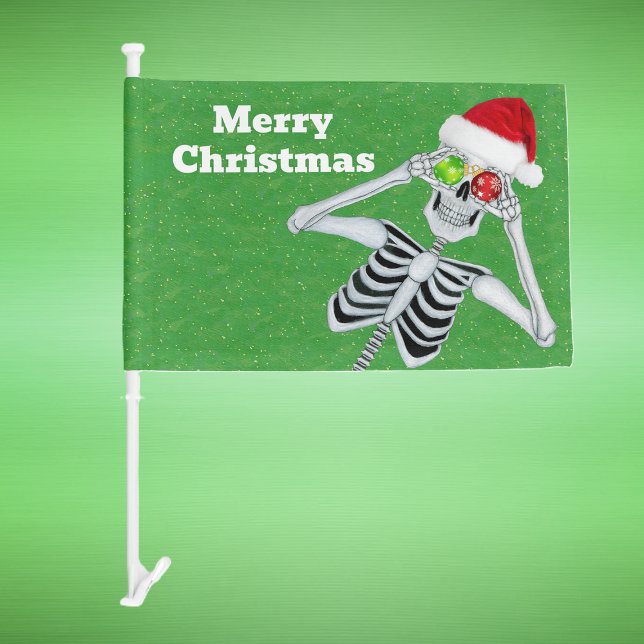 Christmas Skeleton Ornament Eyeballs Hat Green Car Flag (Fun Christmas skeleton holding ornaments up to eyes on green with gold specks car flag.)