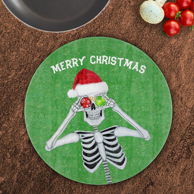 Christmas Skeleton Shiny Ornaments Green Gold  Cutting Board (Smiling Christmas skeleton shiny ornaments Santa hat on green with gold specks glass cutting board.)