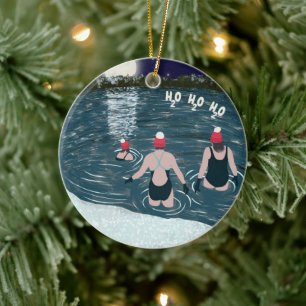 Christmas swimming in snowy lake in Santa hats Ceramic Ornament