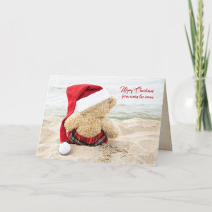 Christmas teddy bear on beach holiday card