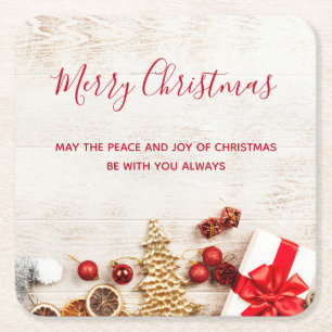 Christmas Themed Items on a Faux Wooden Board Square Paper Coaster