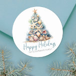 Christmas Tree Beach Happy Holidays Classic Round Sticker<br><div class="desc">Happy Holidays Beach Christmas Tree Classic Round Sticker. Spread some beachy holiday cheer with this unique round sticker featuring a Christmas tree made of shells and starfish. The tree, topped with a starfish, is designed in calming blue and green hues, reminiscent of underwater coral, and is set against a sandy...</div>