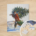 Christmas Tree |  N.C. Wyeth Jigsaw Puzzle<br><div class="desc">Christmas Tree – Chadds Ford (1922) | N.C. Wyeth’s 1922 painting, Christmas Tree – Chadds Ford, beautifully captures a wintry Christmas scene of a man carrying a freshly cut tree through the snow-covered countryside of Chadds Ford, Pennsylvania. The man is bundled warmly, with his sturdy stance conveying the effort of...</div>