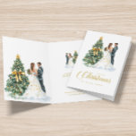 Christmas Tree Wedding Couple Our First Christmas Card<br><div class="desc">This festive greeting card features watercolors of a wedding couple standing by a Christmas tree,  and gold typography with personalizable text.</div>