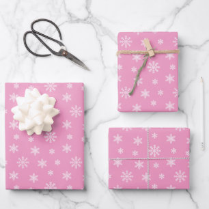 Christmas white snowflakes on pink background wrapping paper sheets