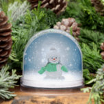 Christmas winter snowman SlipperyJoe green scarf m Snow Globe<br><div class="desc">Christmas winter snowman SlipperyJoe green scarf mittens gloves rosy cheeks gray fur hat sparkles snowflakes background gay pride gifts LGBTQIA artistic adorable festive wintery feel</div>