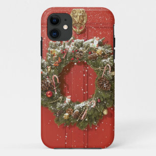 Christmas wreath hanging on a door iPhone 11 case