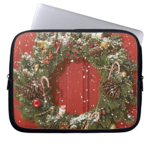 Christmas wreath hanging on a door laptop sleeve
