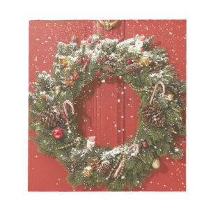 Christmas wreath hanging on a door notepad