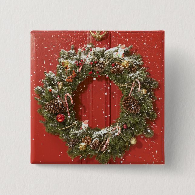 Christmas wreath hanging on a door pinback button (Front)