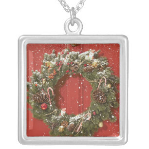 Christmas wreath hanging on a door silver plated necklace