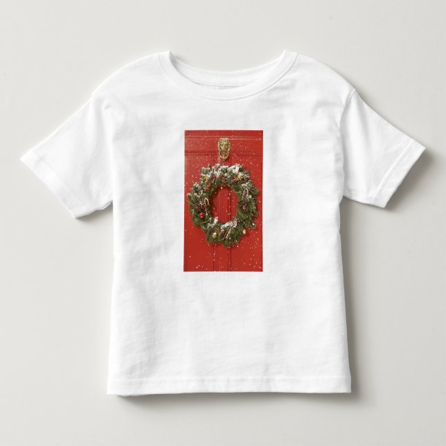 Christmas wreath hanging on a door toddler t-shirt (Front)